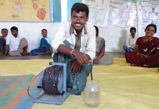 A farmer in India testing a groundwater dip meter (photo: Ruth Meinzen-Dick).