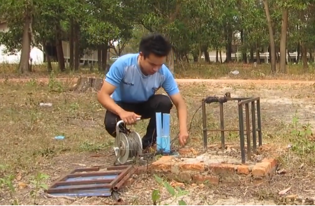 Figure 1- Taking measurements on groundwater level changes due to rainfall and surrounding usage in Lao PDR
